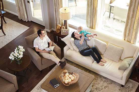 man and woman lounging in living room with infant